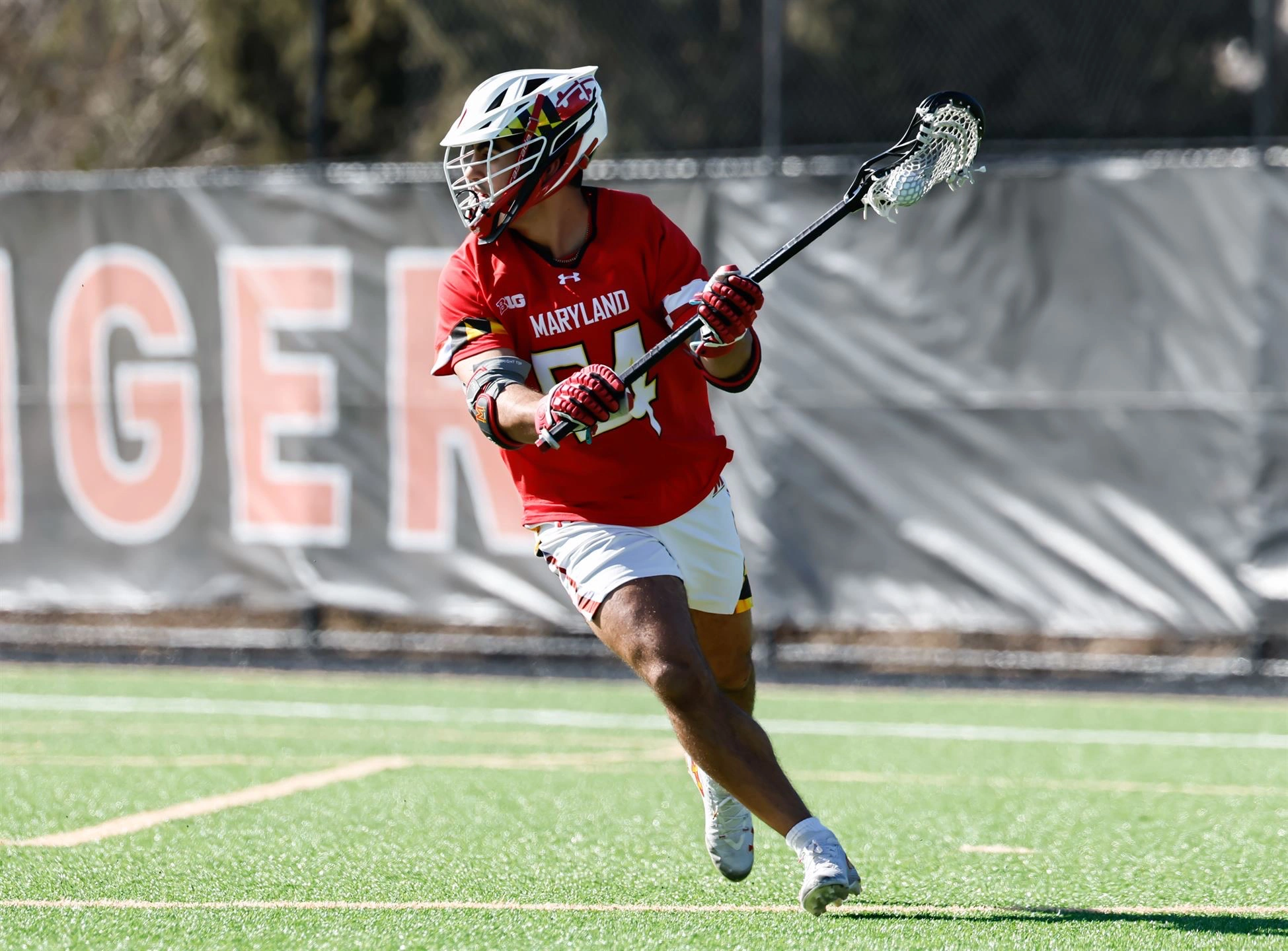 AJ, a University of Maryland long-stick midfielder, running with the ball